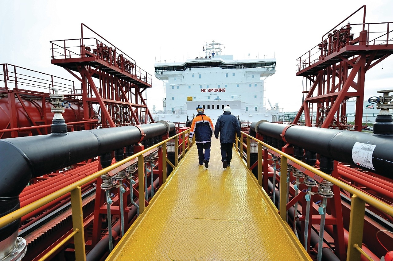Shell employee walking along on a tanker 