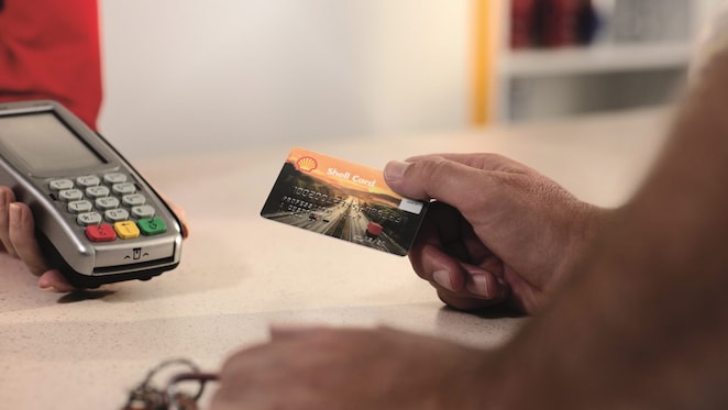a hand, holding euroShell card