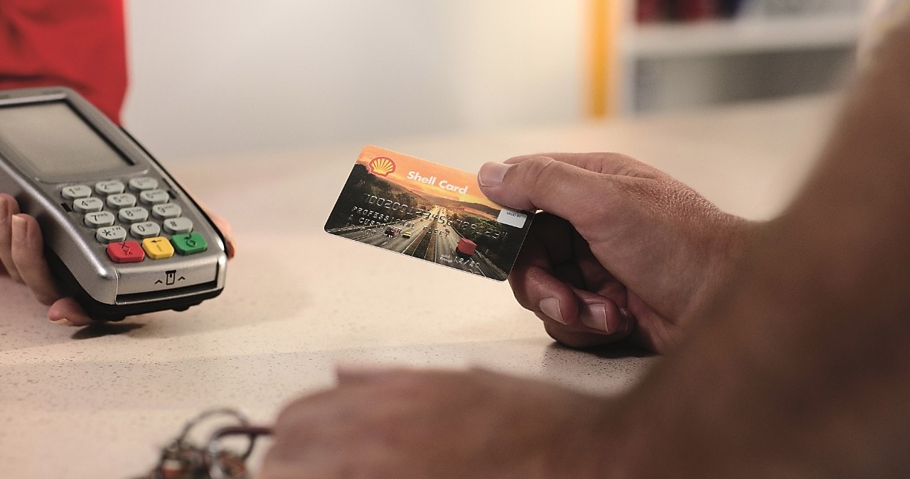 a hand, holding euroShell card